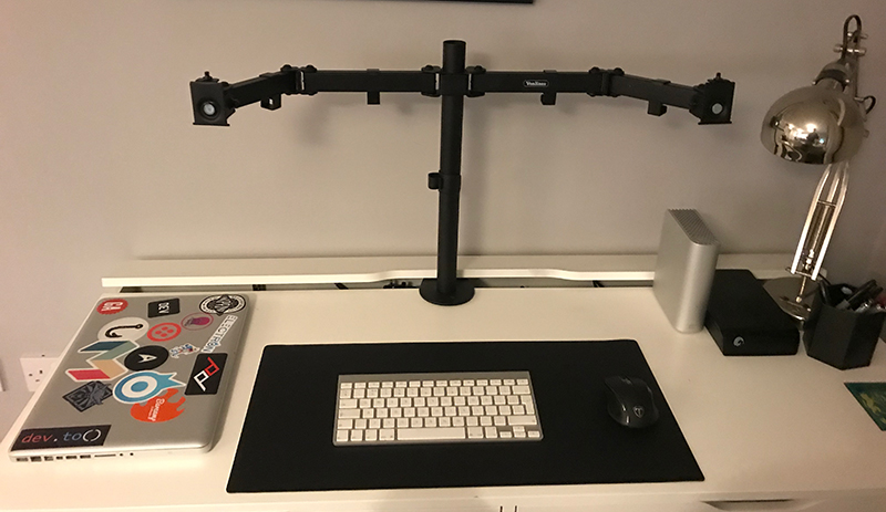 The monitor arm mounted to my desk